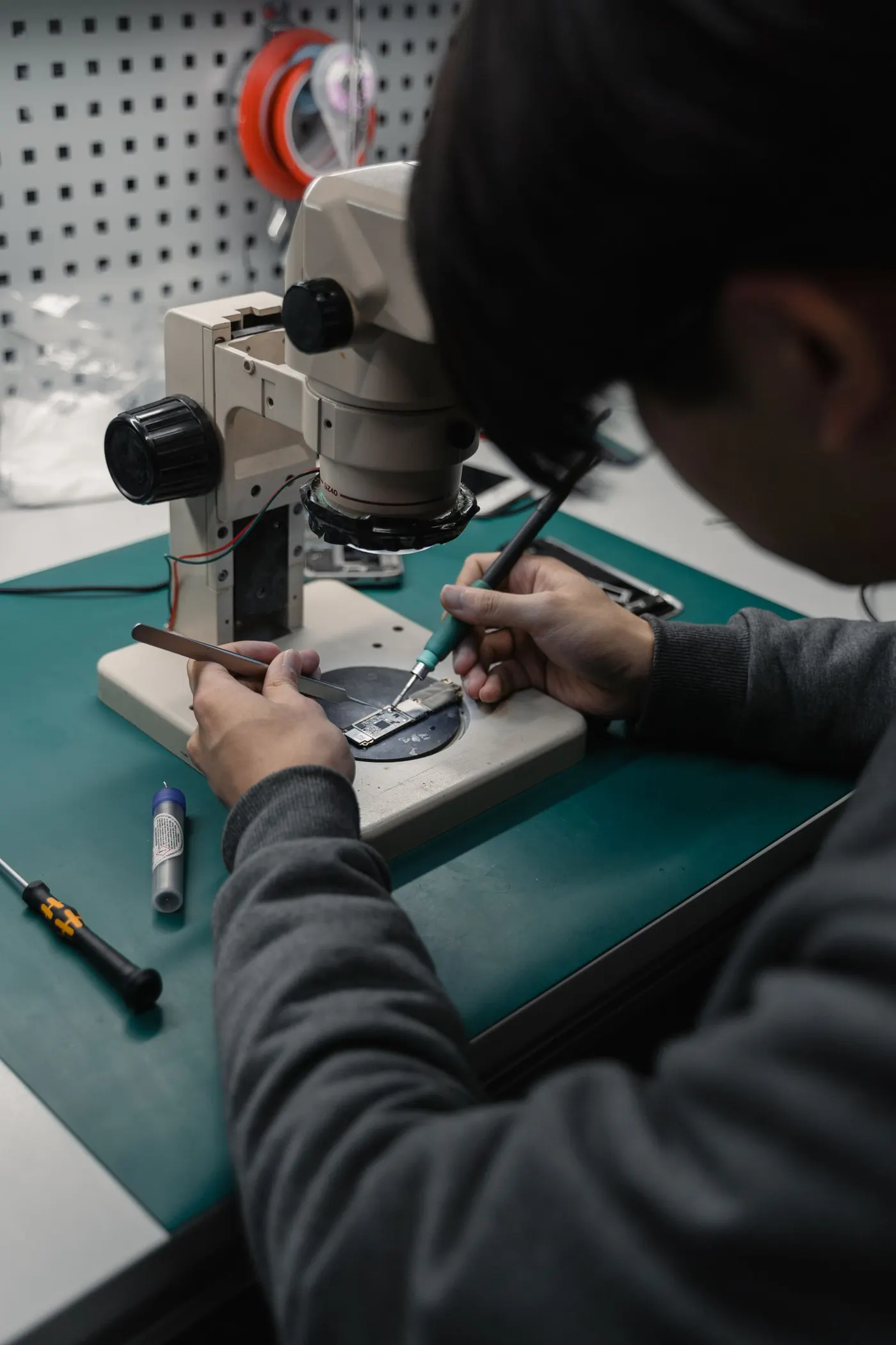 Soldering a circuit board under a microscope